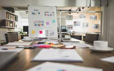 The meeting room provided for meetings has coffee cups, business papers, graphs and desks. Concept meeting room business.