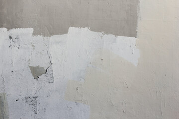 The texture of the beige and gray areas on the gray wall.