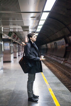 Young man waiting his train on platform..