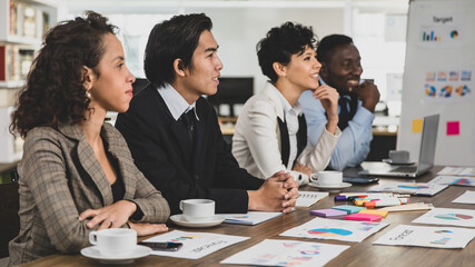 Business men and women of different nationalities are attending the meeting happily and smiling In the meeting room at the office. Concept happy meeting smile.