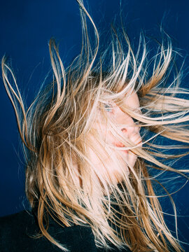 Blonde girl with wind in hair.