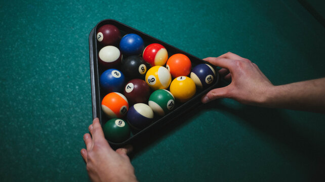 Man setting up the balls for snooker