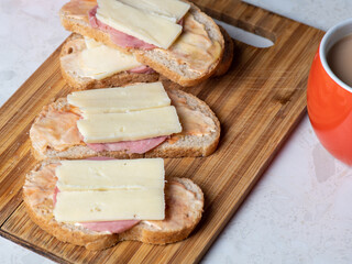 A cut in half sandwich sitting on top of a wooden cutting board