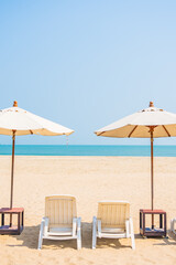 Umbrella and chair around beach sea ocean on blue sky