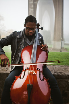 Man playing cello outdoors