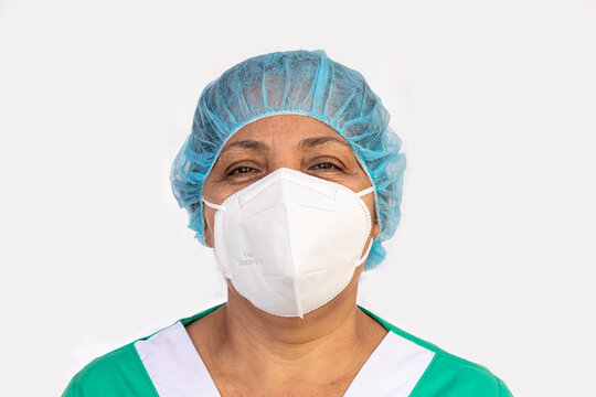 Latina Nurse Wearing Hair Net KN95 Mask And Medical Scrubs Clothes Working In A Hospital For The Prevention Of Covid-19. Medical And Health Concept