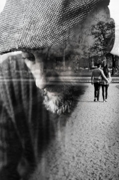 Double exposure of a very sad man who recalls his younger age