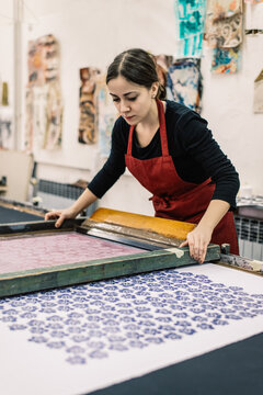Female textile designer doing screen printing