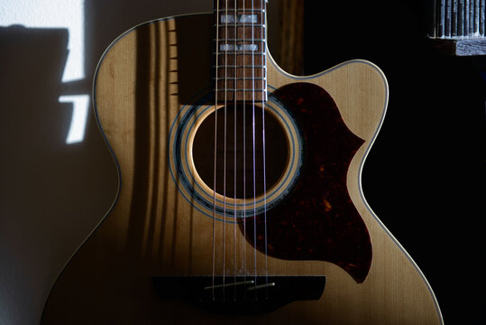 Guitar in soft, partial lighting.