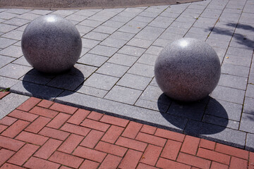 decorative granite balls spheres on sidewalk