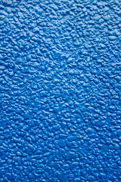 Close up of painted blue stucco wall