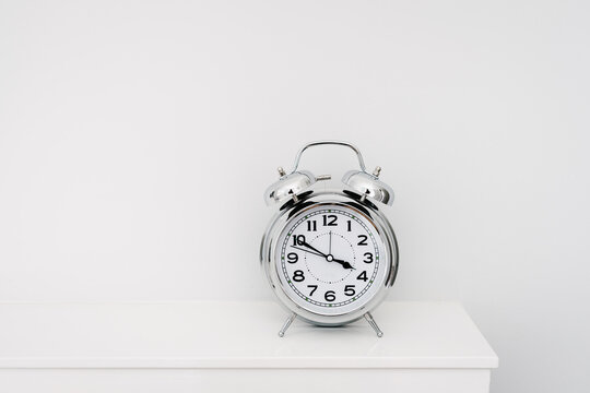 chrome retro clock on mantelpiece