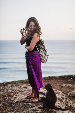 Woman playing with a monkey