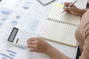 Fototapeta premium Financial businessman calculating corporate income tax data And analyzing charts of financial stocks that are in good condition with growth and progress, Investment in finance and accounting.