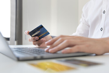 Fototapeta premium Online product purchase, Businessman use laptop register via credit cards to make online purchases, Shopping and mail, credit card online security, Online shopping concept.