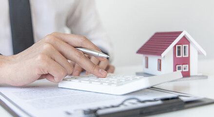 Sales manager or real estate agent will be prepared to show you a sample home and detail the terms of buying a home with insurance promotions, Attention to property services and insurance concept.