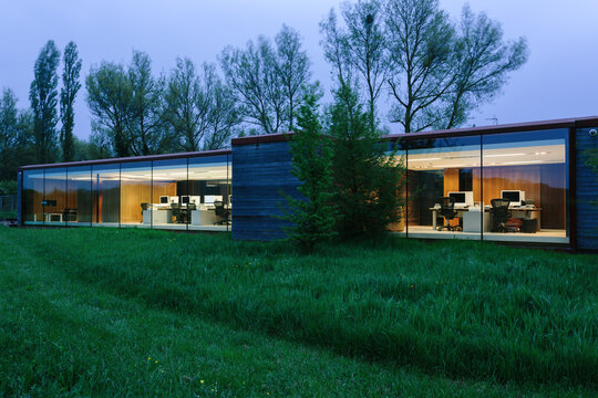 Eco-friendly office building at twilight. Looking in to the building
