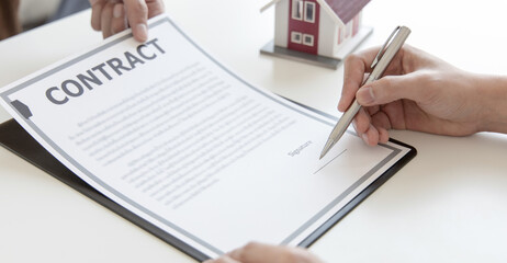 Real estate agent or sales manager has proposed terms and conditions to customers who sign house purchase agreements with insurance, Agreement to sign the purchase contract concept.