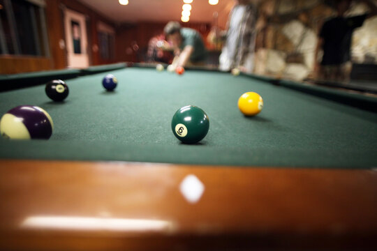 Person Playing Pool Showing Close Up of Table
