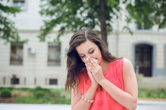 Young woman blowing her nose