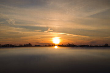 Naklejka premium The setting sun reflecting on the car roof.