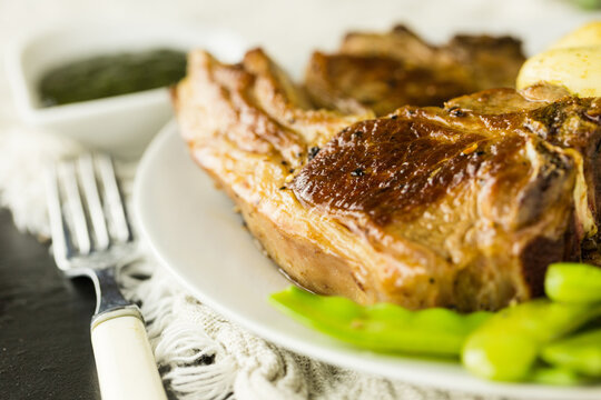 Meat And Two Veg Dinner Of Lamb Chops With Mangetout And New Potatoes