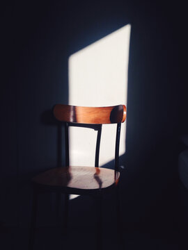 Sunlit chair through a window