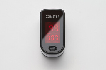 Top view of portable digital fingertip oximeter isolated on white background