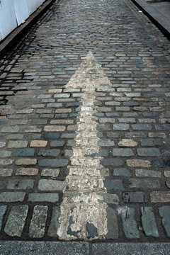 One Way Arrow on Cobblestone Street