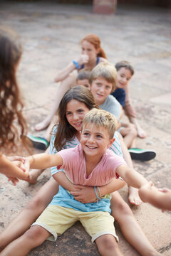 Group of children playing together a game of strength