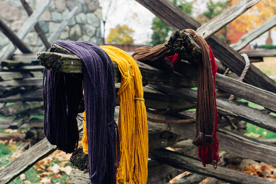 Natural dyed wool drying on a fence