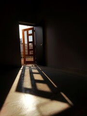 Sunlight coming through door in a dark room