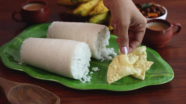 Rice Puttu white Pittu , Kadala Chickpea curry , milk tea , popular South Indian breakfast steamed rice cake 4K slow motion video footage Kerala Tamil Nadu India Sri Lanka. rice flour grated coconut  
