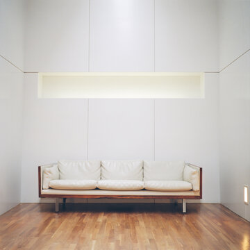 Retro leather couch in modern, minimalist hotel lobby