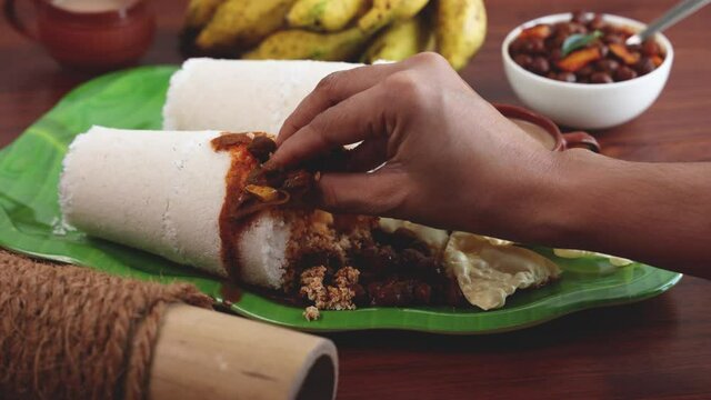 Rice Puttu white Pittu , Kadala Chickpea curry , milk tea , popular South Indian breakfast steamed rice cake 4K slow motion video footage Kerala Tamil Nadu India Sri Lanka. rice flour grated coconut  