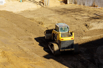 Small tractor digging land working with land