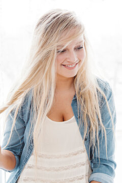 Portrait of smiling young woman with long blonde hair