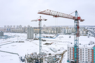 construction site with cranes in winter time. aerial photography with drone