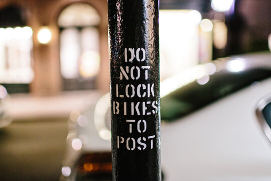 Stencil of the words ""Do Not Lock Bikes to Post""