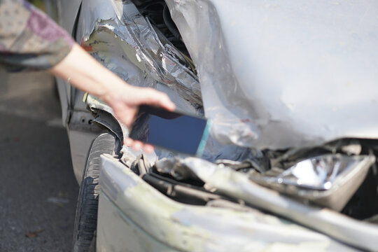 hand take photo of crashed damaged broken car. automobile crash accident