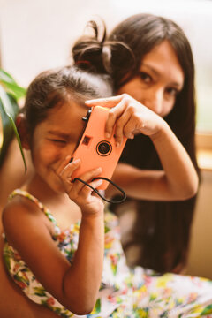 Young Girl and Mother looking at a Camera