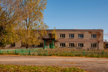 Autumn sky over  village with small wood colored local house and low fence in the mountains and fields. Travelling on the suburb roads. People living