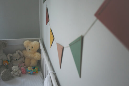 A cute baby room with colorful garland. Pastel tones.