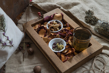 dried fruits and herbal tea on a wooden background