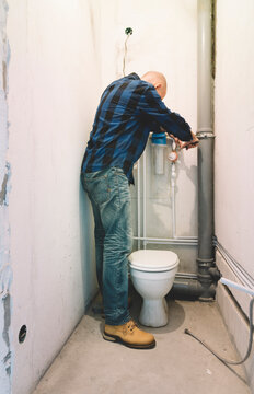 Plumber installing plastic pipes