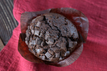 Chocolate muffin close-up on a raspberry napkin