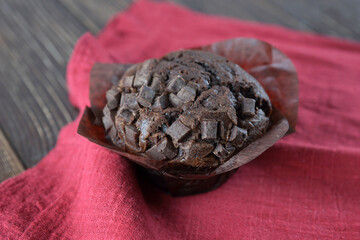 Chocolate muffin close-up on a raspberry napkin