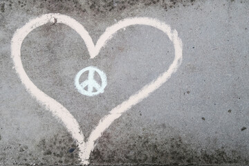 Heart and peace symbol on grey concrete