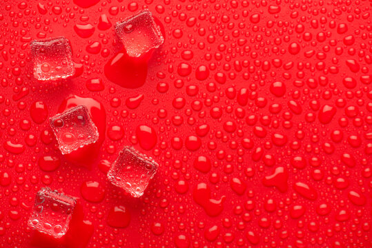 Top above overhead macro close up view photo picture of ice cubes on bright red backdrop with rainy drops