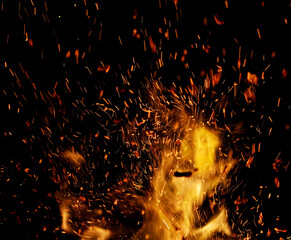 flame of fire with sparks on a black background